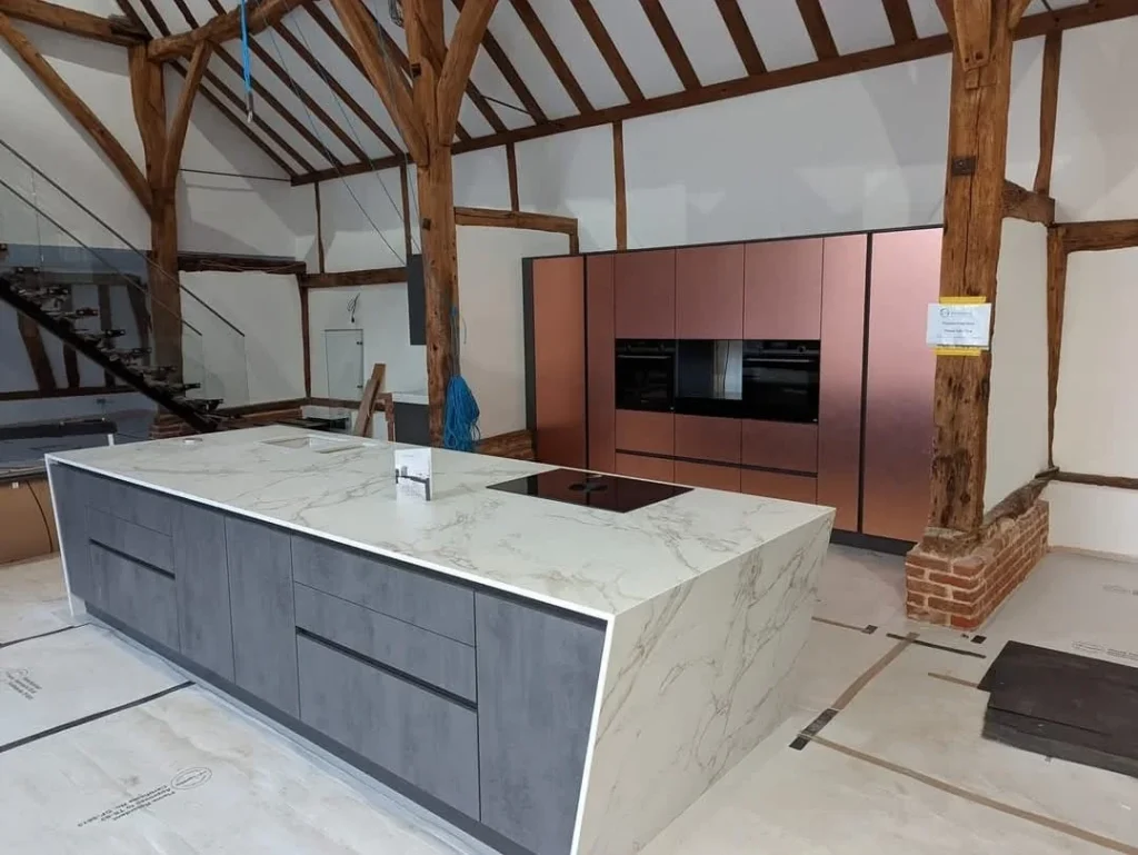https://fixandflip.sdsdigitalsolutions.com/wp-content/uploads/2026/08/barn-conversion-kitchen-exposed-beams-copper-cabinetry-1024x769.webp