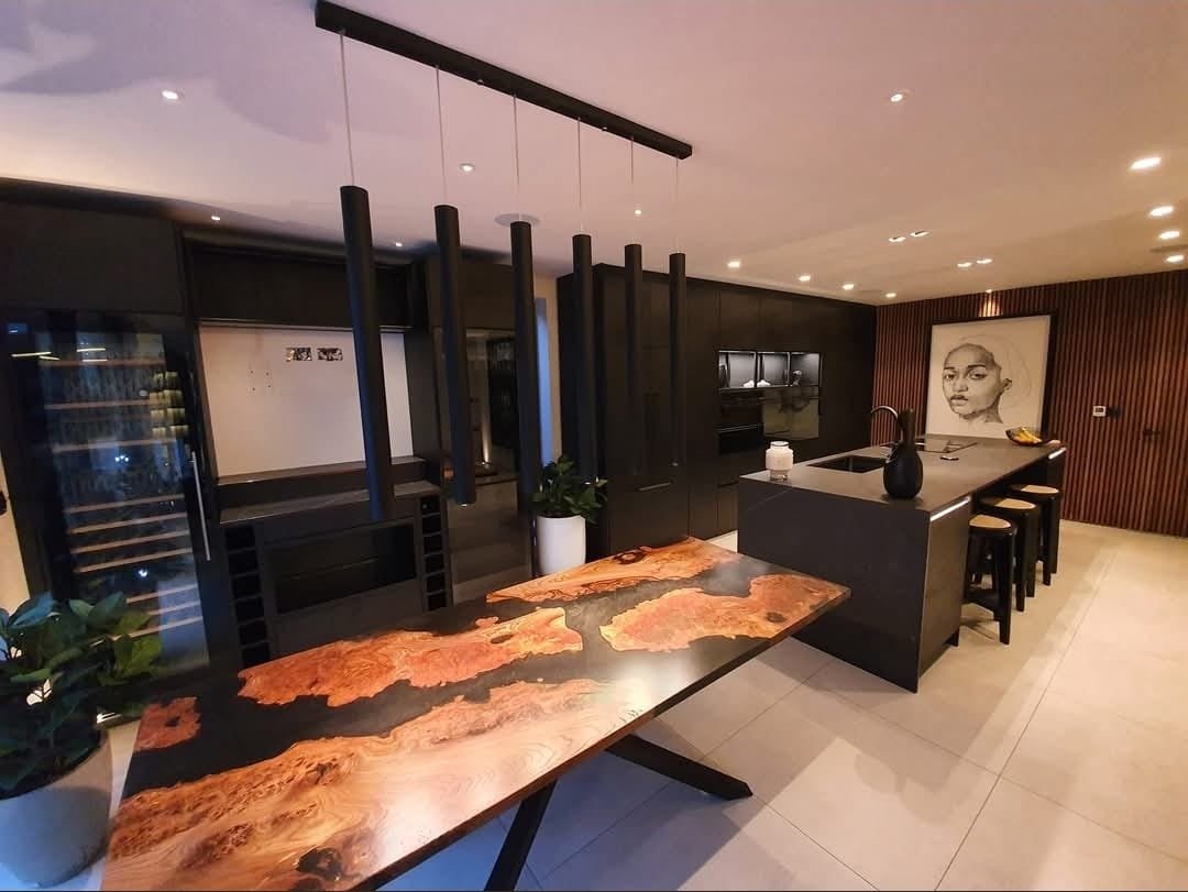 https://fixandflip.sdsdigitalsolutions.com/wp-content/uploads/2026/08/bespoke-live-edge-dining-table-dark-kitchen.jpg