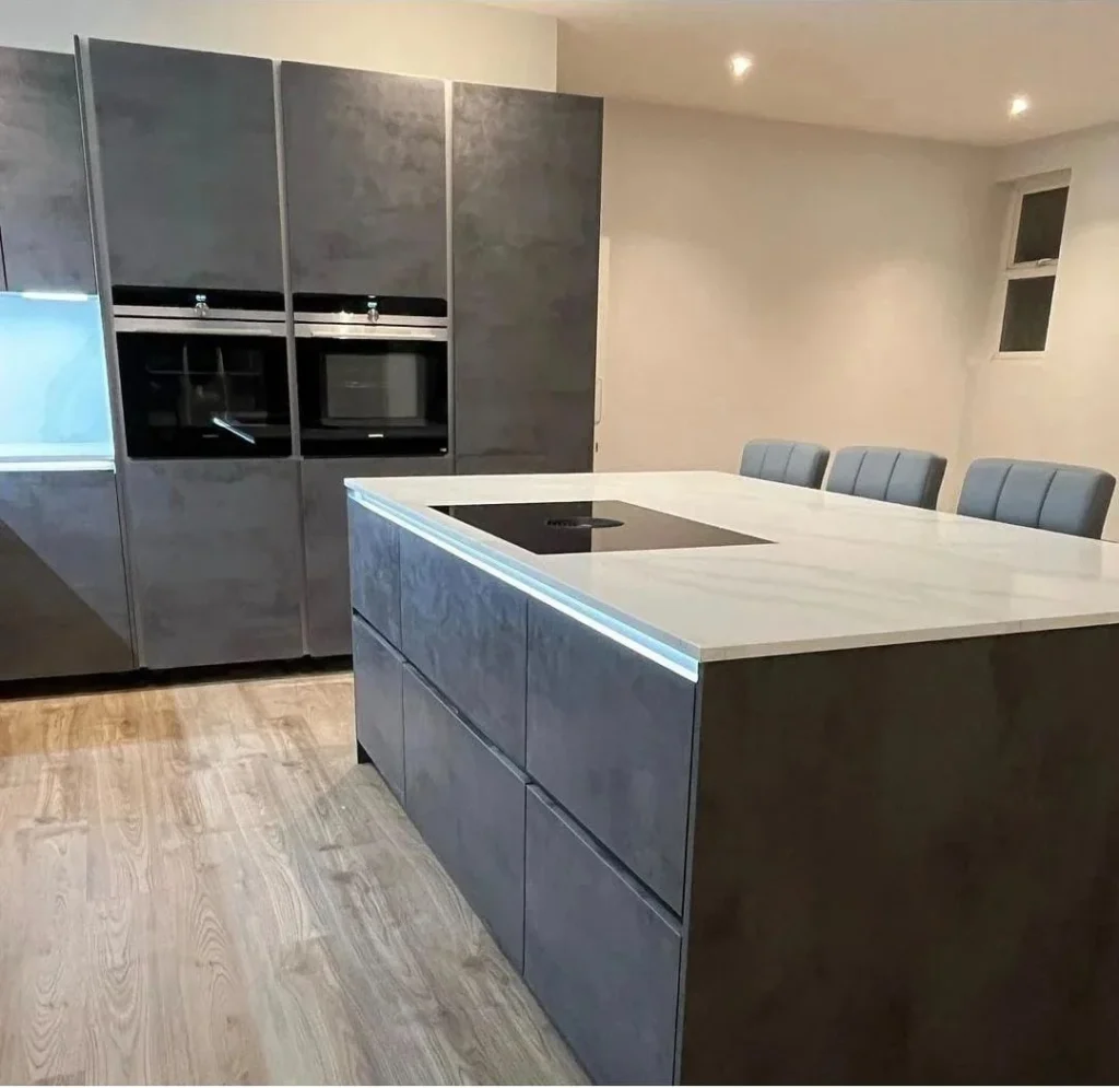 https://fixandflip.sdsdigitalsolutions.com/wp-content/uploads/2026/08/grey-stone-effect-kitchen-double-ovens-island-1024x995.webp